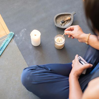 A peaceful setting with a yoga mat and candles.
